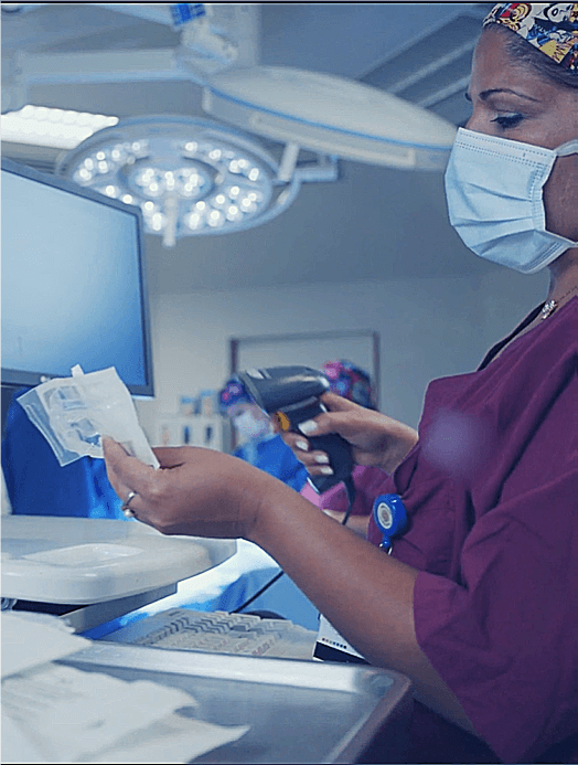 A nurse struggling to chart chargeable items via barcode while in surgery